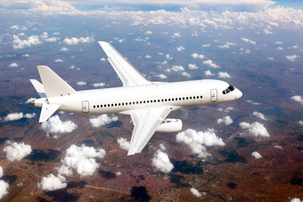 istock White passenger plane fly high above the clouds. View from above. 1396490506