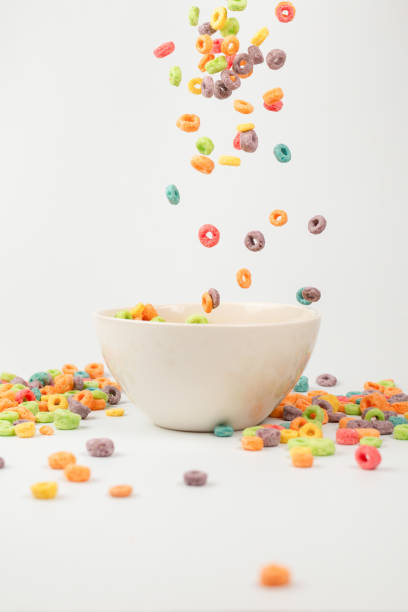 istock Colorful cereal box for morning breakfast. Corn flakes falling to the white bowl. Motion. 1396493639