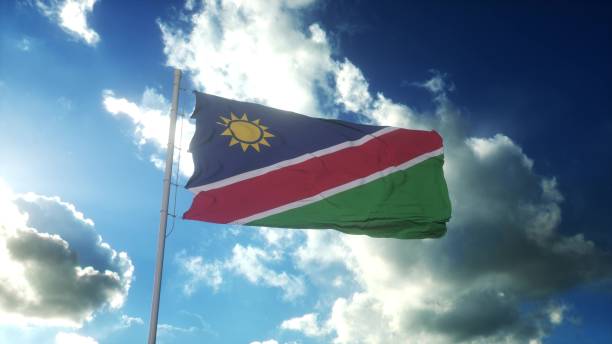 istock Flag of Namibia waving at wind against beautiful blue sky. 3d rendering 1396494322