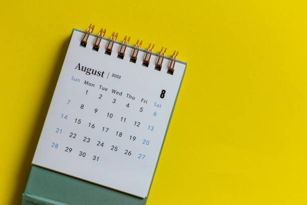 istock Desktop mini calendar for August 2022 on the table. 1396494707