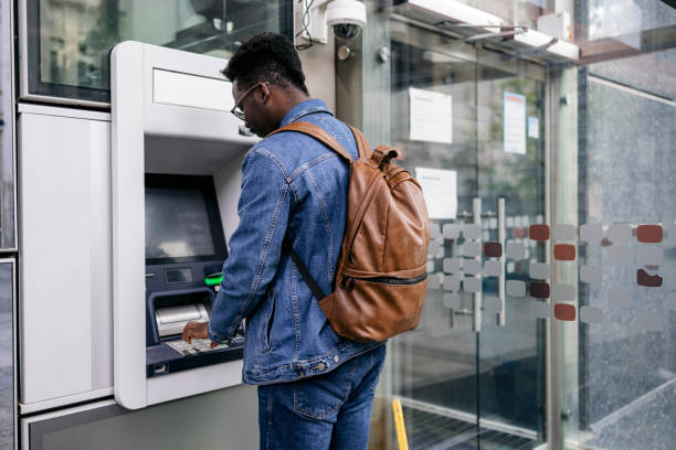 istock Young man retrieving money from his bank account 1396495457
