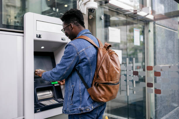 istock Young man retrieving money from his bank account 1396495471