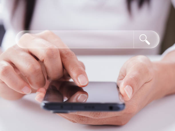 istock Search Engine Optimization, searching information online, Women use smartphone to search data on internet finding information Website online. Concept of SEO, Mobile, Smartphone, Technology, Digital 1396495542