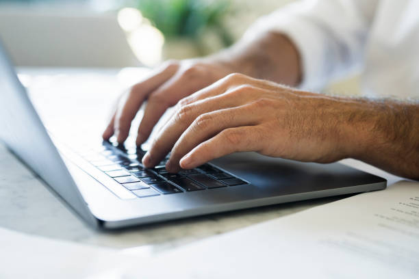 istock Businessman tapping on a laptop keyboard 1396495760