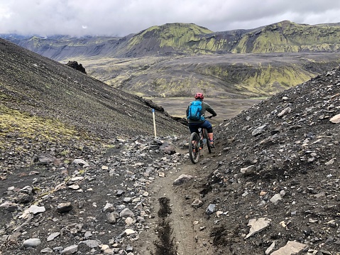 Icelandic backdrop mountain biking down a rock and black ground
