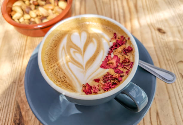 istock Hipster coffee with latte art and rose petals 1396497819
