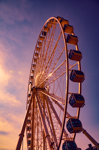 A Ferris wheel at dusk in Myrtle Beach, SC. The sky is Neapolitan with blue, red, orange and yellow