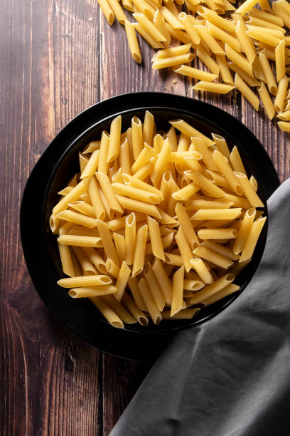 istock Raw pasta on wooden background, cooking themes, space for text 1396499329