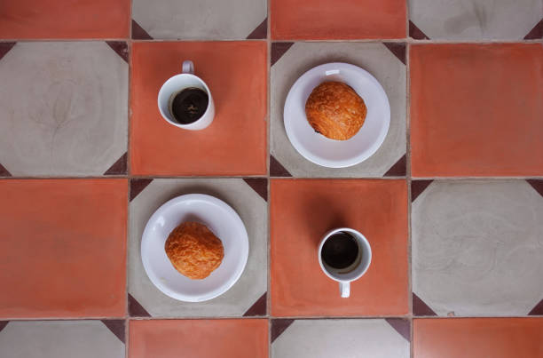 istock Espresso and pain au chocolat on a tiled floor 1396499700