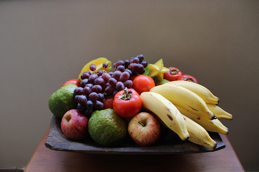 Autumn harvest concept. Seasonal fruits and vegetables on a wooden table, top view