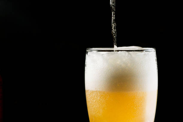 istock Close-up Beer isolated in black background 1396501063