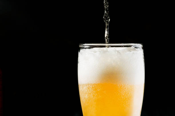 istock Close-up Beer isolated in black background 1396501075