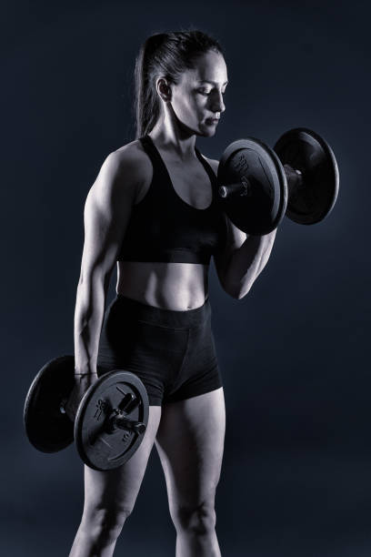istock Strong fitness lady doing biceps curls 1396501094