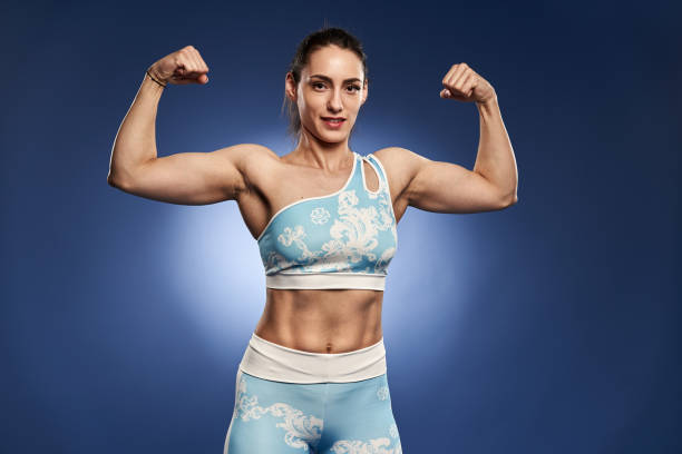 istock Strong athletic woman on blue background 1396501159