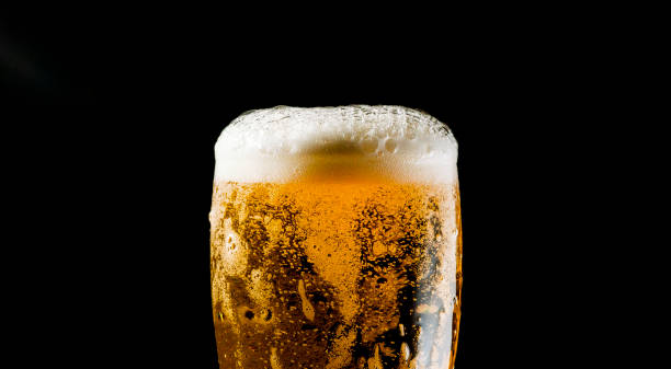 istock Close-up Beer isolated in black background 1396501238