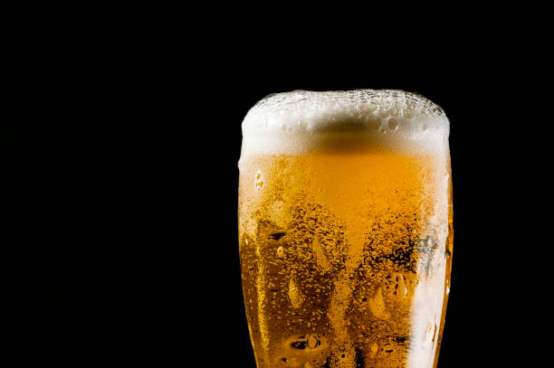 istock Close-up Beer isolated in black background 1396501240