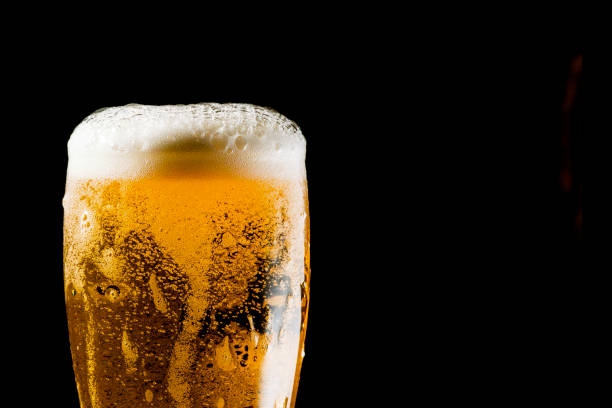 istock Close-up Beer isolated in black background 1396501242