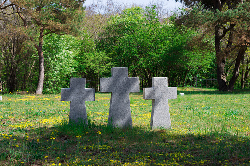 Baltiisk, Russia - 05.10.2022: granite stone grave crosses at the German memorial cemetery in Pillau
