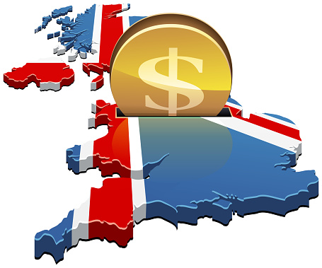 A coin with the symbol of the American dollar is inserted into a slot of the 3D map of the United Kingdom in the colors of the British flag like a piggy bank