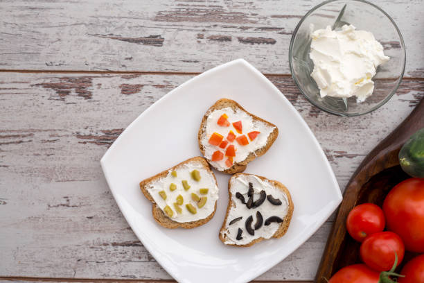 Butter and bread for breakfast, over rustic wooden background close up