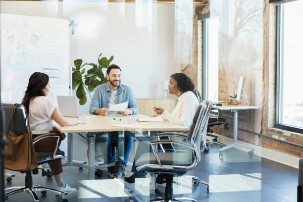 istock Three diverse co-workers meet to discuss budget and plan 1396502803
