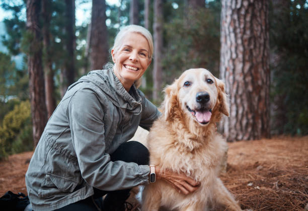 Shot of a senior woman out for a hike with her dog He's my favourite hiking partner senior dog stock pictures, royalty-free photos & images
