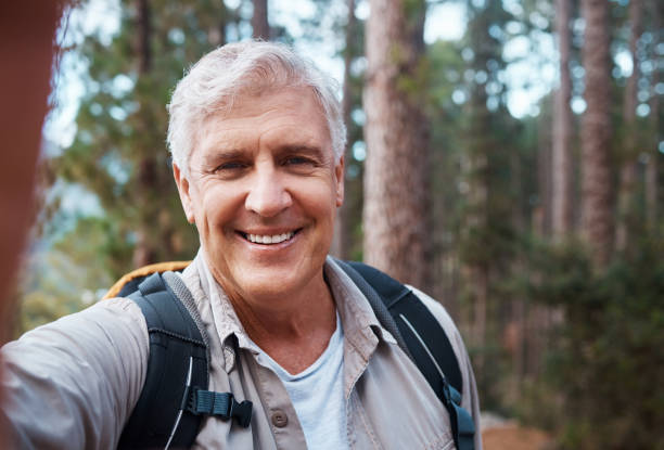 istock Shot of a senior man taking a selfie while out for a hike 1396504269