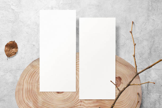 istock Clean minimal flyer mockup on wooden plate with stick and leaf background 1396504498