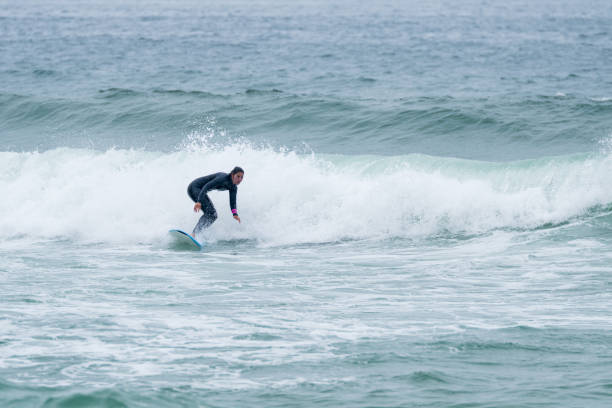 istock Surfer girl riding a wave 1396506280