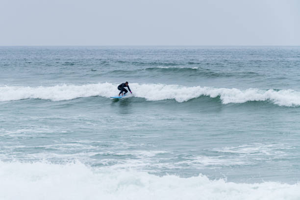 istock Surfer girl riding a wave 1396506305