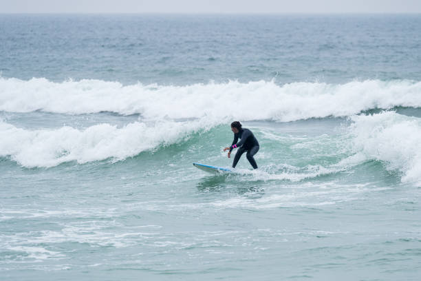 istock Surfer girl riding a wave 1396506393