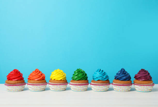 istock Many delicious colorful cupcakes on white table against light blue background. Space for text 1396506631