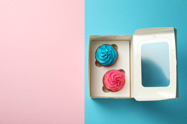 istock Box with different delicious cupcakes on color background, top view. Space for text 1396506663