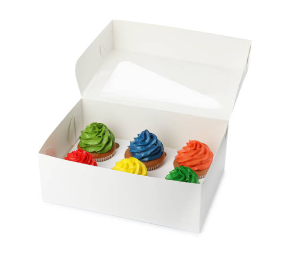 istock Box with delicious colorful cupcakes isolated on white 1396507392