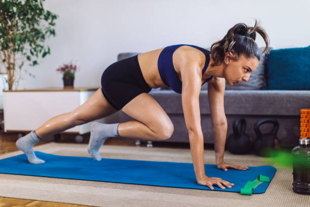istock Young woman doing fitness workout training at home 1396507643
