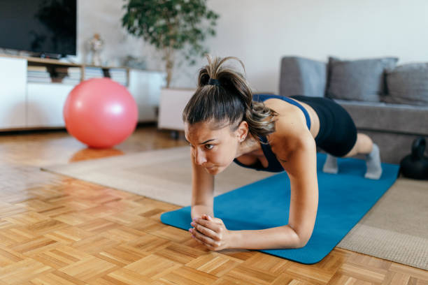 istock Young woman doing fitness workout training at home 1396507802