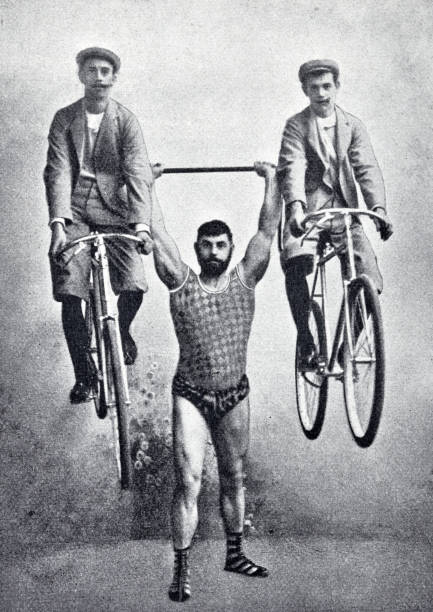 Hercules Georg Stangelmaier holds up two men seated on bicycles Illustration from 19th century. body building stock illustrations