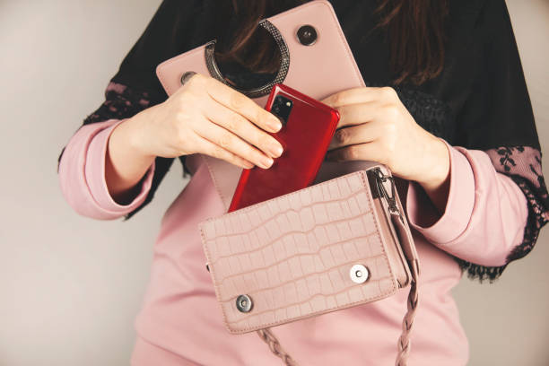 istock woman hand phone in bag 1396510777