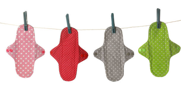 many different cloth menstrual pads hanging isolated on white - love hanging indoors studio shot imagens e fotografias de stock