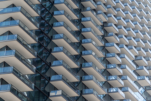 Background of modern luxury apartment balconies. This huge buildings are concentrated in the cities, lowering the quality of life of the inhabitants, reducing their privacy. The image is symbolic of real estate speculation and the lack of a sustainable way of life.