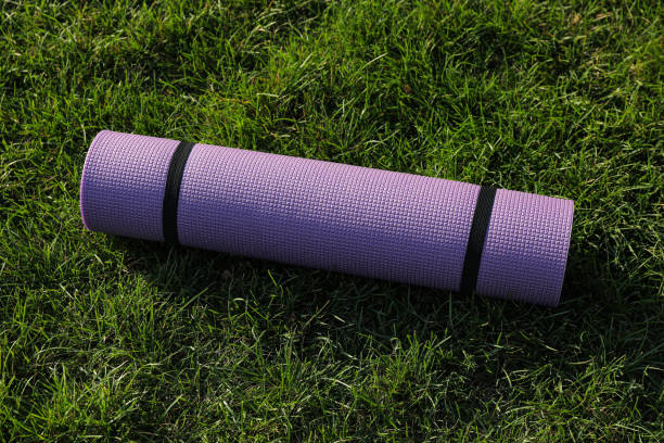 istock Bright exercise mat on fresh green grass outdoors 1396513307
