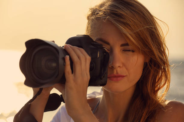 istock Photographer taking photo with professional camera outdoors, closeup 1396513643
