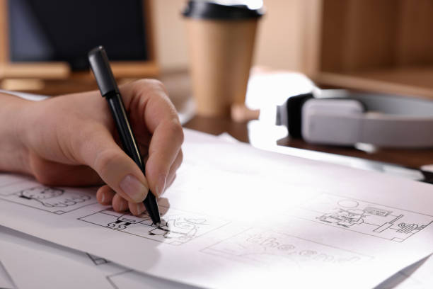 istock Woman drawing cartoon sketch at workplace, closeup. Pre-production process 1396513663
