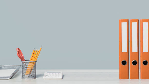 istock Colorful document binders or lever arch file on a shelf or desk banner 1396515927