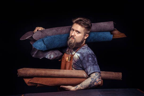 Artisan working with leather keen on one's business .