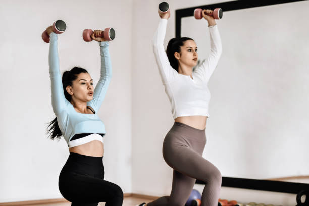 istock Female Athletes Working On Lunge Exercise With Weights 1396516162