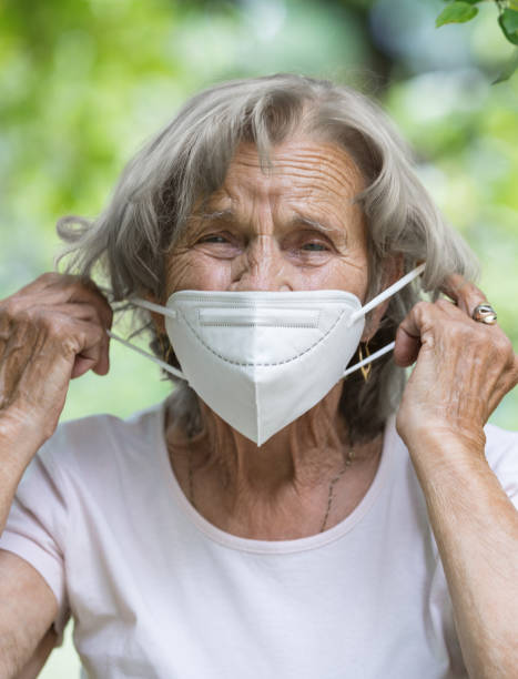 istock Elderly woman wearing a protective face mask against viruses 1396517858