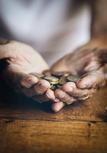 istock Elderly retired woman and her savings 1396517956