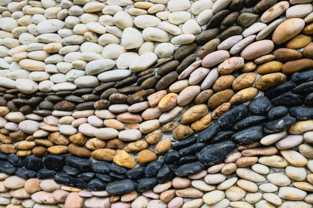 istock Beautiful pebble wall decoration. Background of round pebble design wall. 1396518082