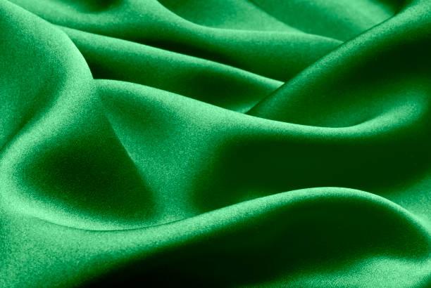 istock green silk forming elegant waves with shadows and chiaroscuro, background of textile material 1396519348